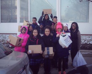 Village Leadership Academy Students deliver composition books they helped collect in the run up to their Reclaim MLK event. (Photo: Holly Krig)
