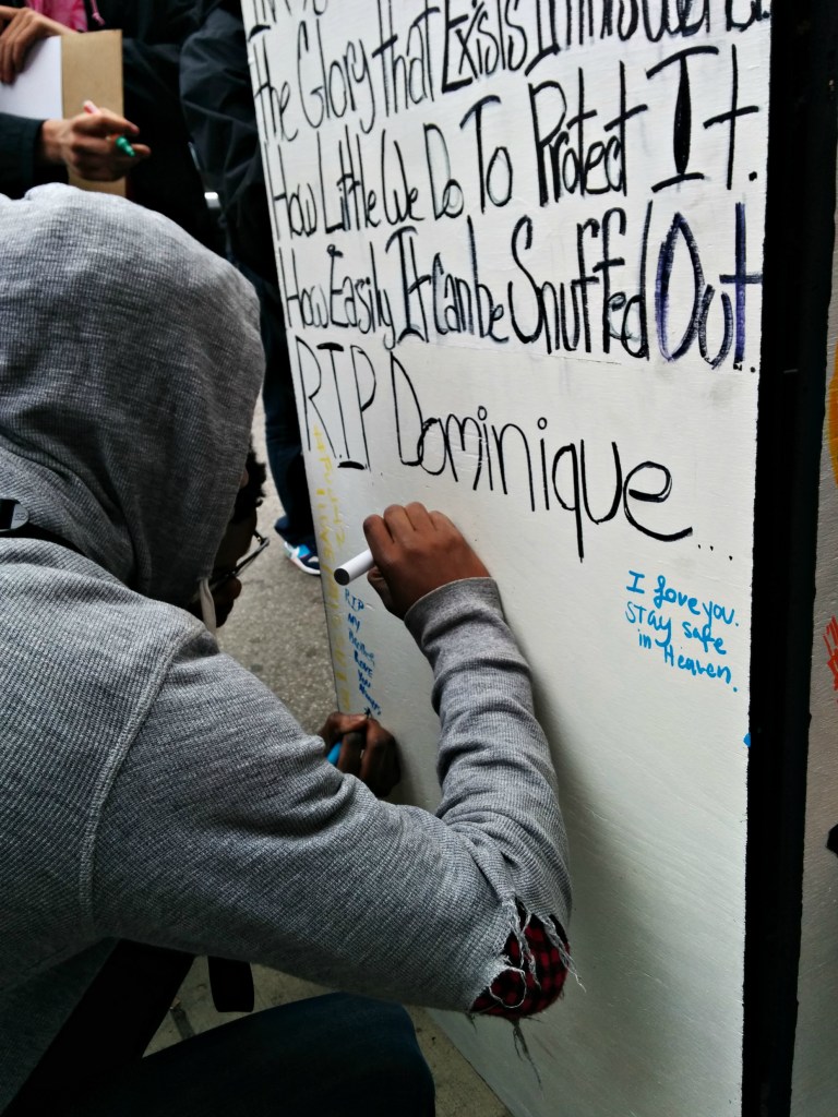 The community memorializes Damo at the spot where he fell after being fatally tased by police. (Photo: Kelly Hayes)